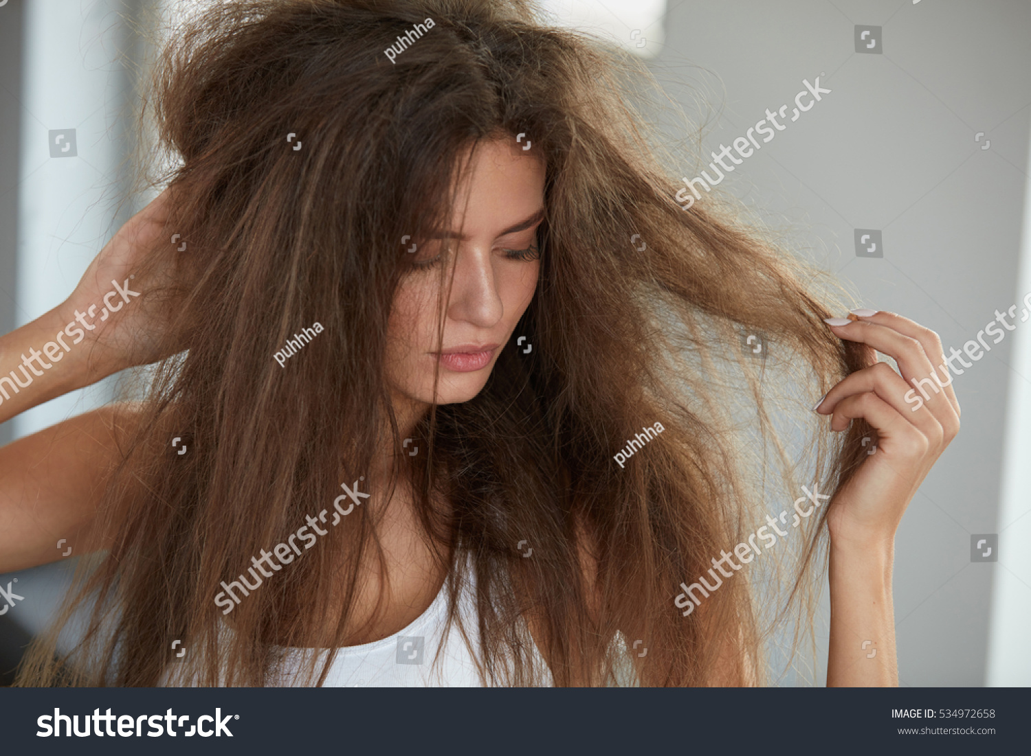 stock-photo-damaged-hair-beautiful-sad-young-woman-with-long-disheveled-hair-closeup-portrait-of-female-model-534972658